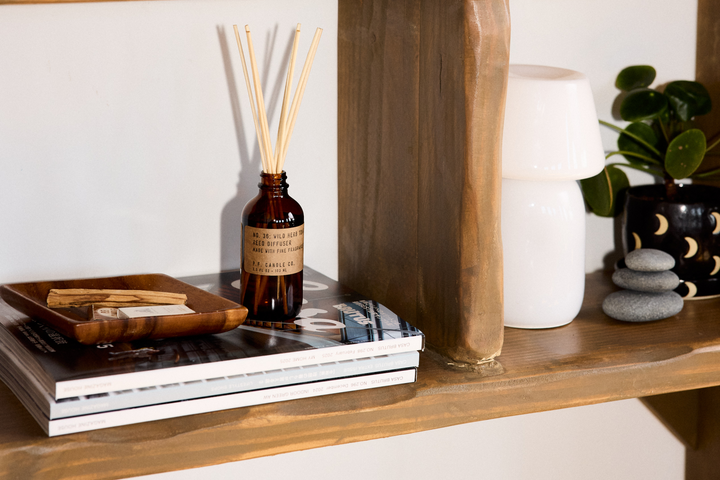 Best-seller reed diffuser sitting on a stack of books
