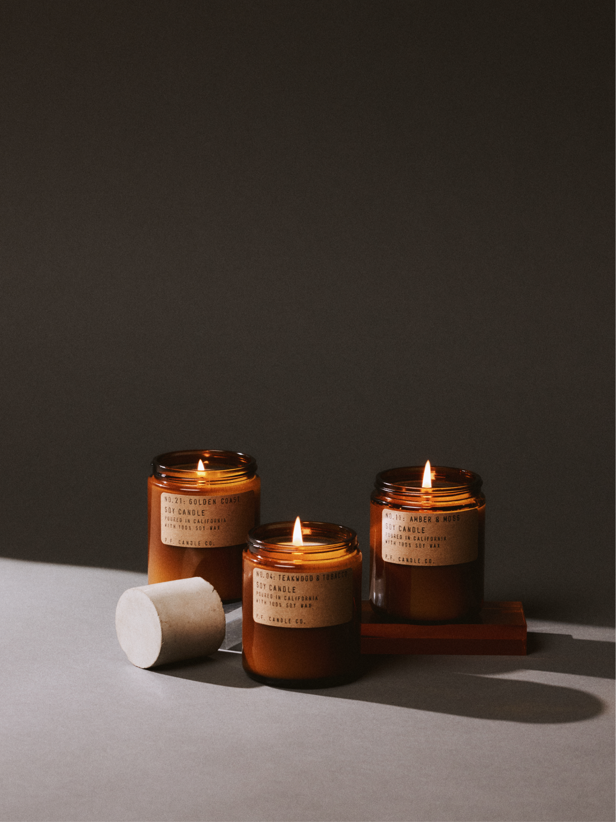 Three lit soy candles arranged together, creating a warm, calming atmosphere for relaxation and mindful reflection.