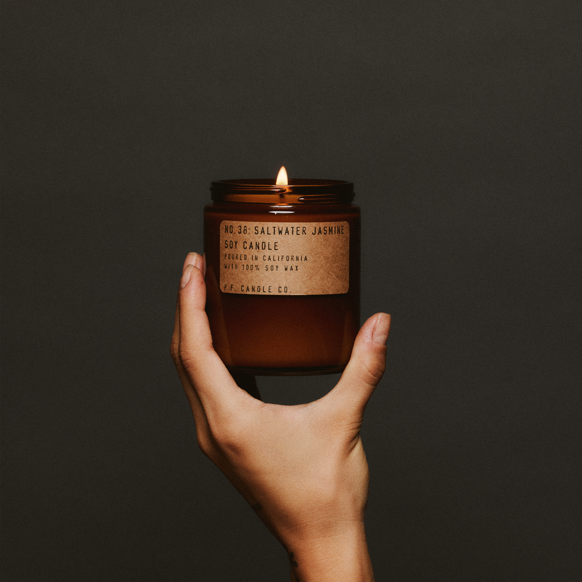 saltwater jasmine standard candle in hand